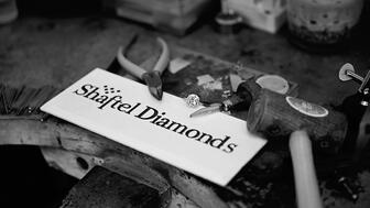 Shaftel Diamonds logo and jeweler’s bench  