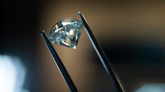 De Beers Group’s sales fell 20 percent in the first half of the year but losses shrank due to cost-cutting measures. Anglo American is in the process of selling the diamond miner and marketer and hopes to have the process completed by the end of the year. Stock image of a polished diamond being held by tweezers