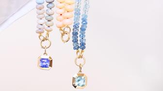 The new Greenwich St. Jewelers x Jewel Boxing capsule collection offers colored gemstone charms that are sold individually, with a gold chain, or with a strand of gemstone beads. Seen here are (from left to right) the “Hyacinth” charm on a hackmanite graduated bead strand, a peach opal bead strand, and the “Hydrangea” charm on a strand of aquamarine beads. Hyacinth Charm on Hackmanite Bead Strand, Peach Opal Bead Strand, Hydrangea Charm on Aquamarine Bead Strand