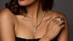 Model wearing diamond necklace and ring