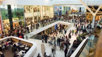 The Conference Board’s monthly U.S. consumer confidence index rose to 97.2 in July from 95.2 in June. Crowd of people in a shopping mall