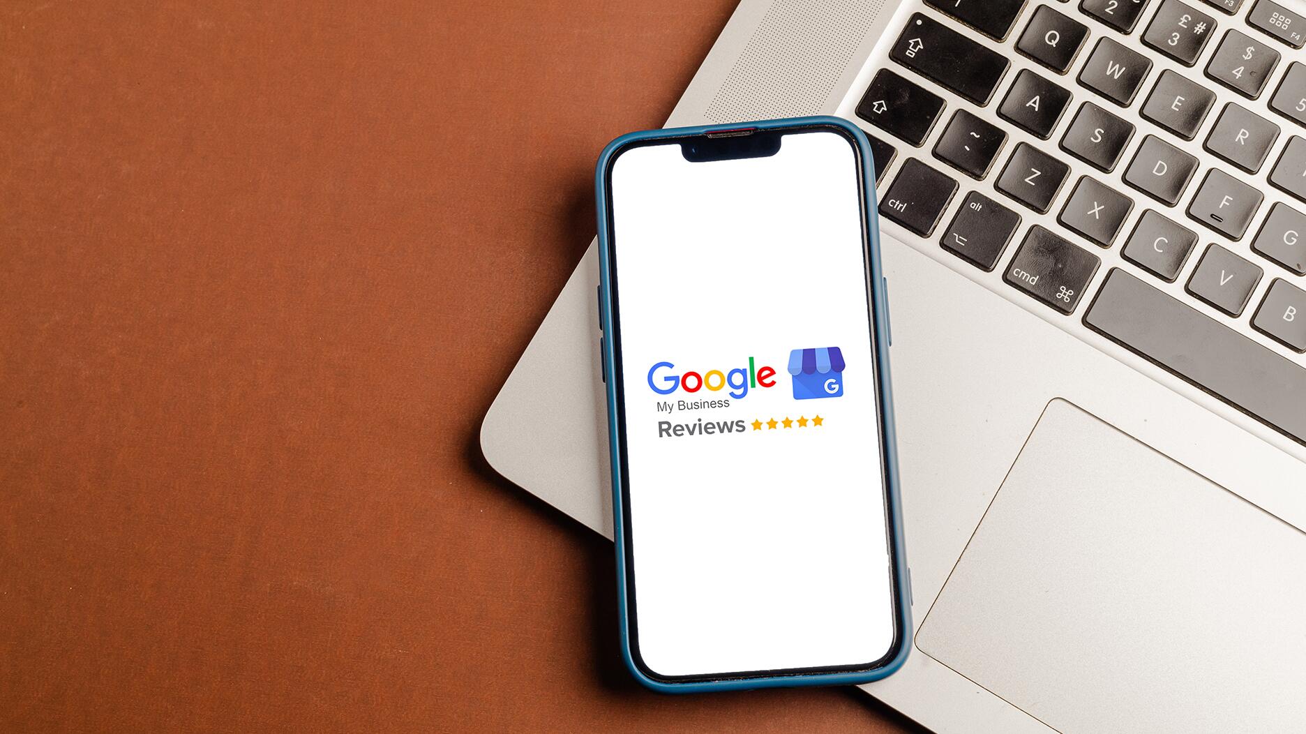 Google reviews on a phone screen and a laptop
