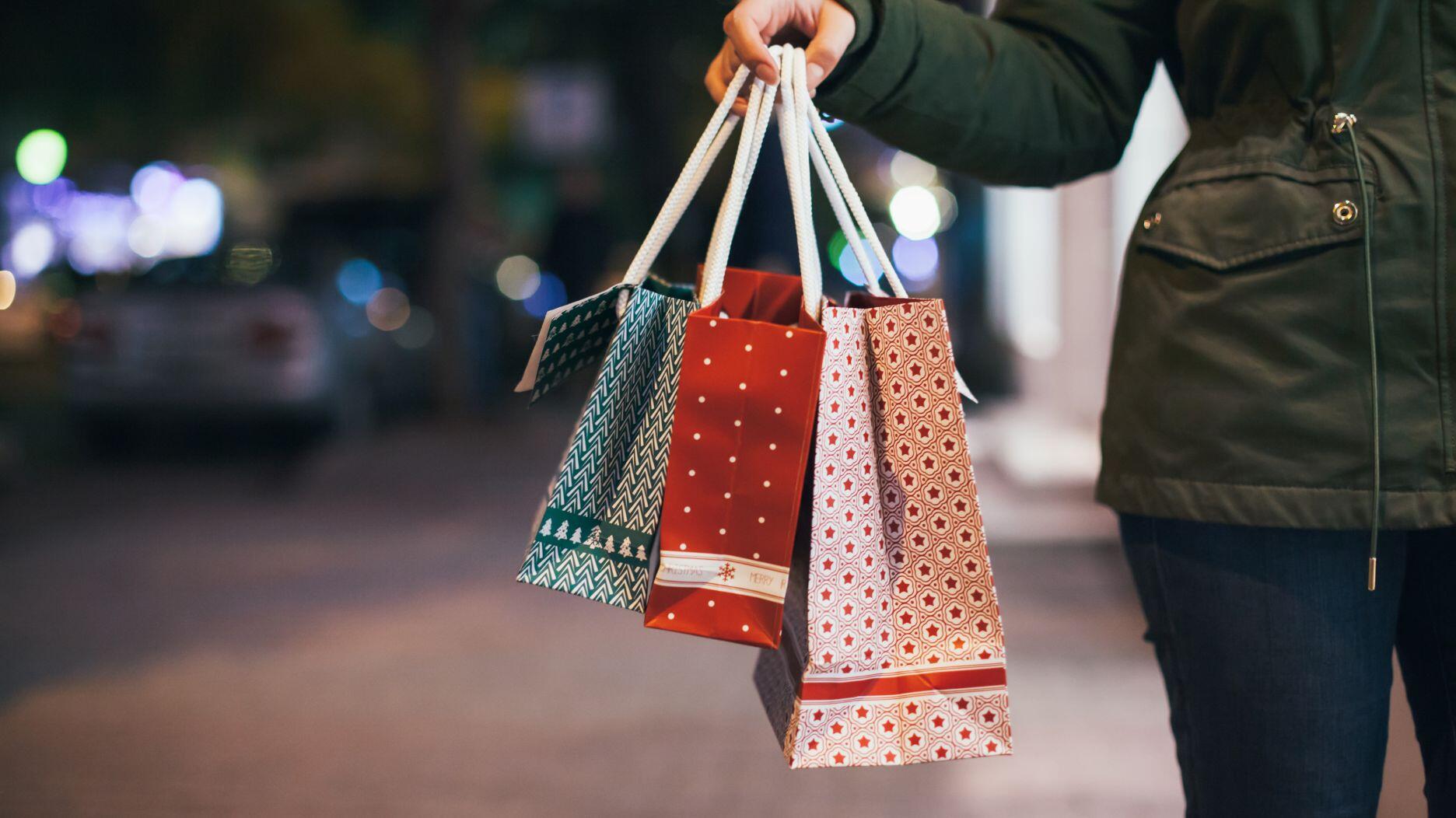 Hand holding holiday shopping bags