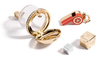 A centerpiece of the “Play” collection is the “Prize Bubble” locket ($8,250) which displays other pieces from the collection, like (from bottom to top) the sterling silver petite “Fortune Dice” ($195), 14-karat yellow gold “Fortune Dice” ($1,850), and the “Continuum Whistle” pendant ($3,750). Mine + Found Play Collection Prize Bubble Locket, Whistle Pendent, Fortune Dice