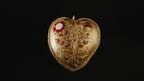 Retained by the British Museum via a public fundraising campaign, the front of the 24-karat gold “Tudor Heart” pendant has a pomegranate plant (right) intertwining with a Tudor rose bush (left), symbols of Katherine of Aragon and Henry VIII, respectively. (© The Trustees of the British Museum) Tudor Heart pendant on display at British Museum