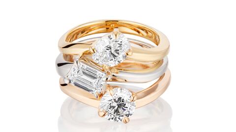 Three engagement rings by designer Lorraine West. From top, they are 18-karat yellow gold with an oval-cut diamond; platinum with an emerald-cut diamond; and 18-karat rose gold with a round diamond. Yellow gold and ovals are two of the top engagement ring trends right now, while the popularity of round diamonds endures. (Photo courtesy of Lorraine West) Diamond engagement rings by designer Lorraine West