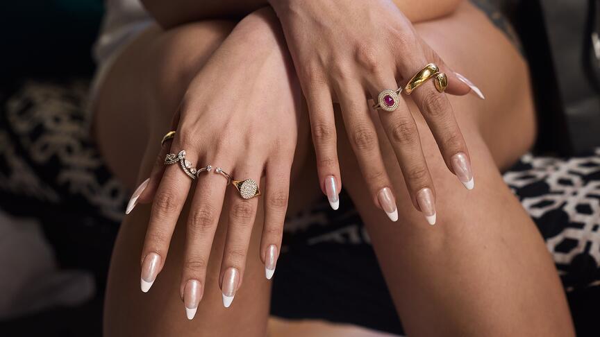 A selection of rings from Signet Jewelers-owned banner Kay Jewelers. The retailer saw Q1 sales increase 2 percent year-over-year. Woman with crossed hands and rings on fingers