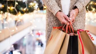 The National Retail Federation is forecasting holiday retail sales will grow 4.2 percent year-over-year to $1.013 trillion. Hand holding shopping bags