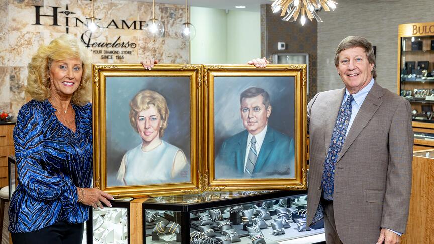 Owner Wally Hinkamp Jr. and Donna Hinkamp Warren are seen here holding portraits of their parents, Ruthene and Walter Hinkamp Sr., who founded Hinkamp Jewelers in 1955 alongside partner Robert Tyndall (not pictured). Wally Hinkamp and Donna Hinkamp Warren