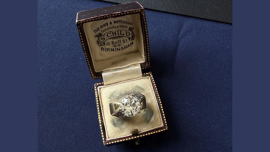 A woman in the UK thought she had purchased a piece of costume jewelry when she bought his ring, but it turned out to be 18-karat gold with a 3-carat diamond. The ring box is not related to the ring; it is just the box that was used to bring the ring to the appraisal event. (Image courtesy of WeBuyVintage) A diamond ring in a jewelry box