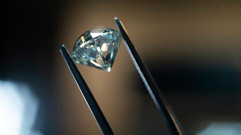 De Beers Group’s sales fell 20 percent in the first half of the year but losses shrank due to cost-cutting measures. Anglo American is in the process of selling the diamond miner and marketer and hopes to have the process completed by the end of the year. Stock image of a polished diamond being held by tweezers