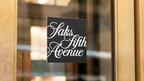 Saks Global plans to lay off 16 percent of its corporate workforce. Saks Fifth Avenue door sign