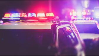 Stock image of police cars with lights flashing 