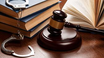 Stock image of gavel, handcuffs, and law books